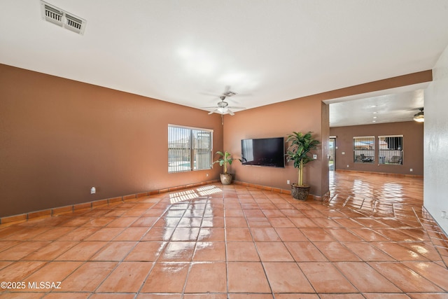 unfurnished living room with ceiling fan and light tile patterned floors