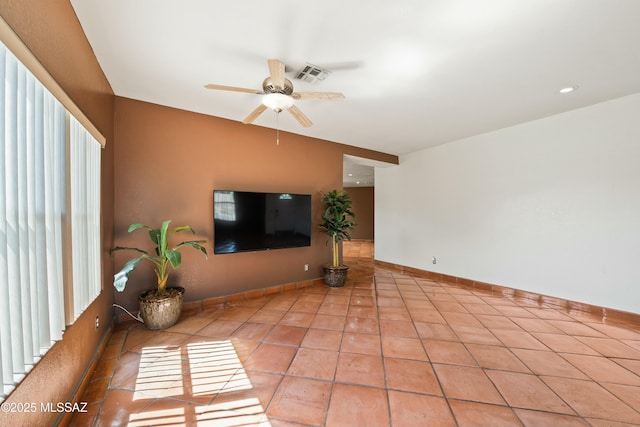 living room with a healthy amount of sunlight, ceiling fan, and light tile patterned flooring