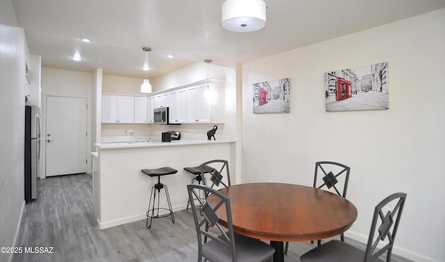 dining space with light wood-type flooring