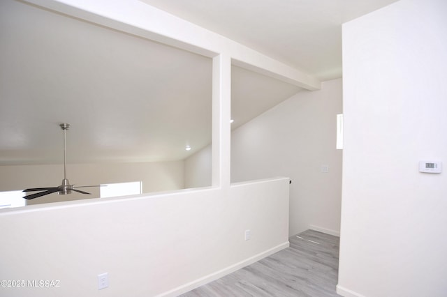 hall with beamed ceiling and light hardwood / wood-style floors