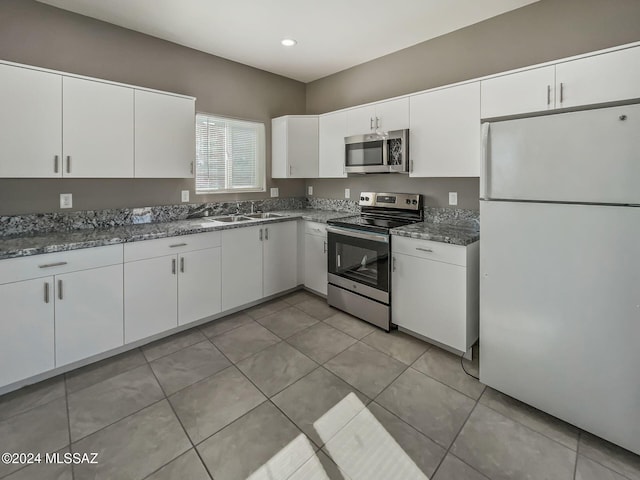 kitchen with sink, white cabinetry, stainless steel appliances, and light tile patterned floors