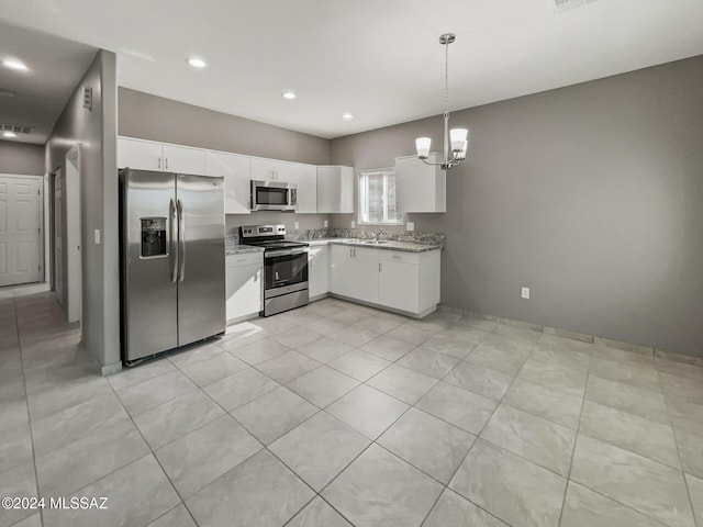 kitchen with white cabinets, hanging light fixtures, light tile patterned floors, a notable chandelier, and stainless steel appliances