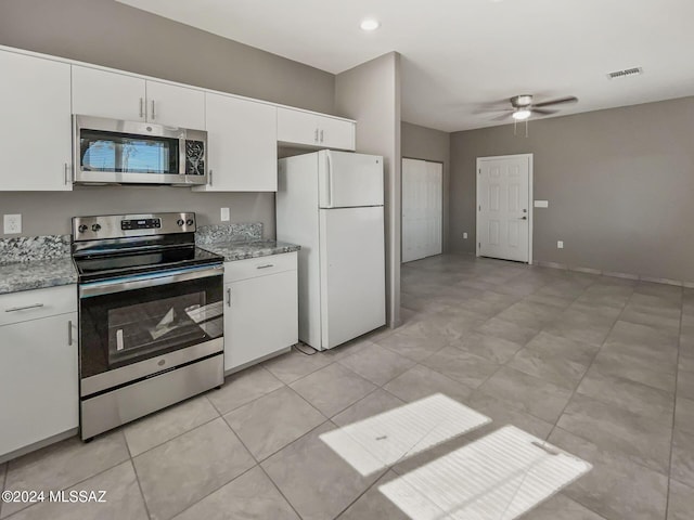 kitchen featuring ceiling fan, white cabinets, and stainless steel appliances