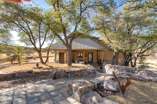 back of property with a patio