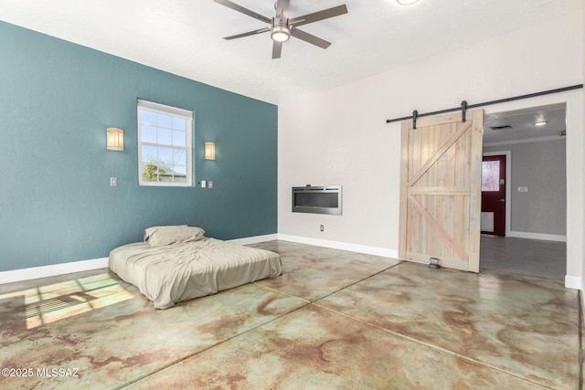 bedroom with ceiling fan, heating unit, concrete floors, and a barn door