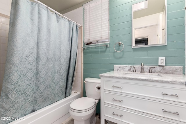 full bathroom with toilet, vanity, and shower / bathtub combination with curtain