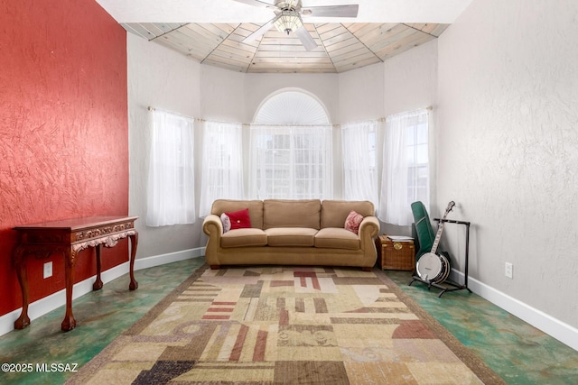 living area featuring ceiling fan, wooden ceiling, and vaulted ceiling