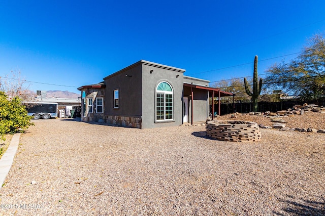 view of side of property with a fire pit