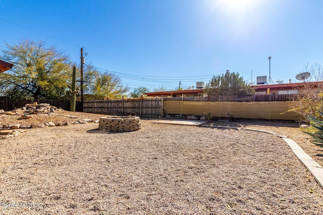 view of yard with an outdoor fire pit