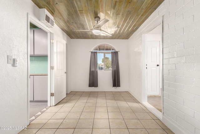 corridor featuring light tile patterned floors and wood ceiling