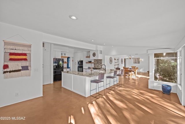 unfurnished living room with a notable chandelier, recessed lighting, finished concrete flooring, and vaulted ceiling