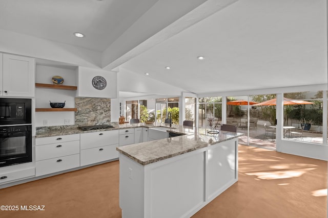 kitchen with black appliances, a sink, open shelves, white cabinets, and light stone countertops