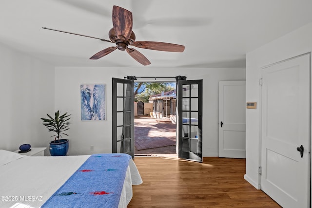 bedroom featuring baseboards, ceiling fan, french doors, wood finished floors, and access to outside