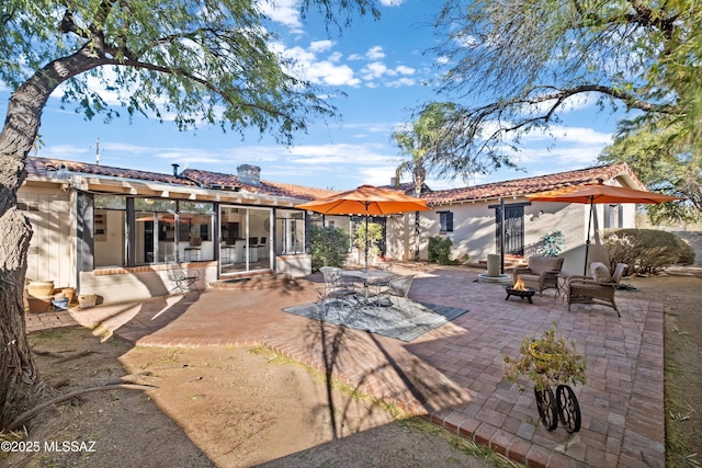 rear view of house featuring french doors, a patio, stucco siding, and a tile roof