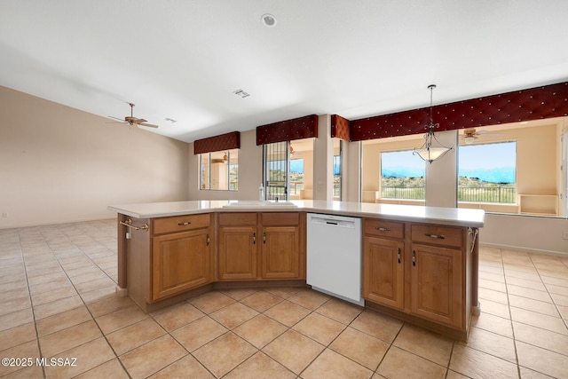 kitchen featuring pendant lighting, dishwasher, a kitchen island, and a wealth of natural light