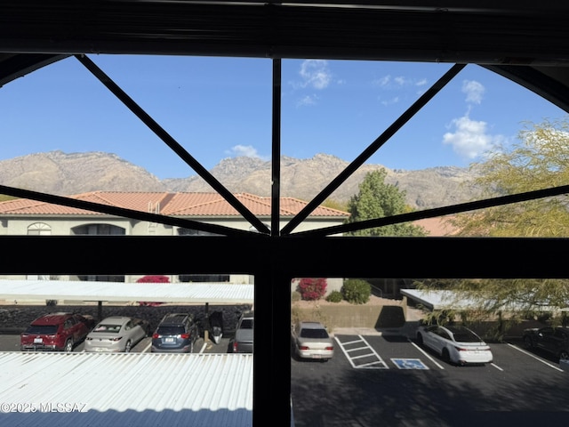 exterior details with a mountain view and a parking lot