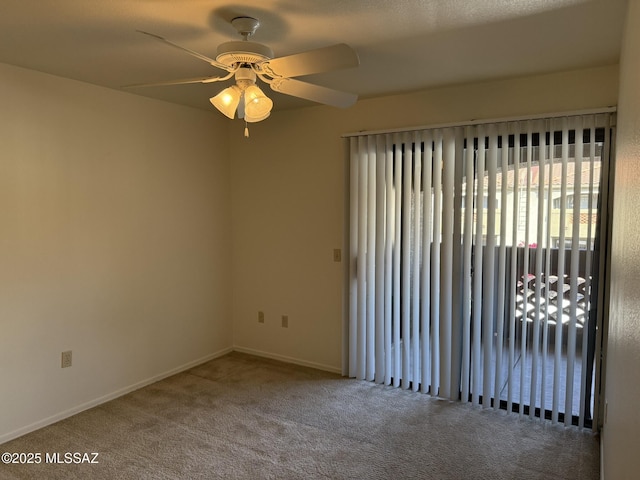 unfurnished room with carpet flooring, baseboards, and ceiling fan