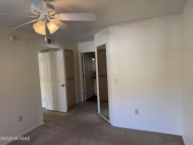 unfurnished bedroom with visible vents, baseboards, and carpet flooring