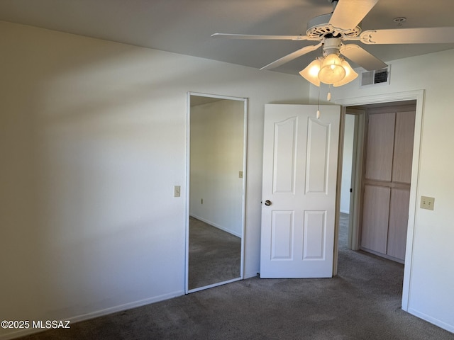 unfurnished bedroom with visible vents, baseboards, carpet, and a ceiling fan