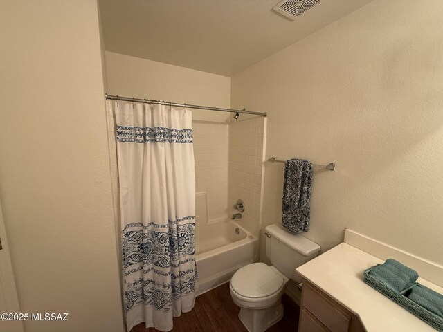 bathroom with visible vents, shower / bathtub combination with curtain, toilet, and wood finished floors