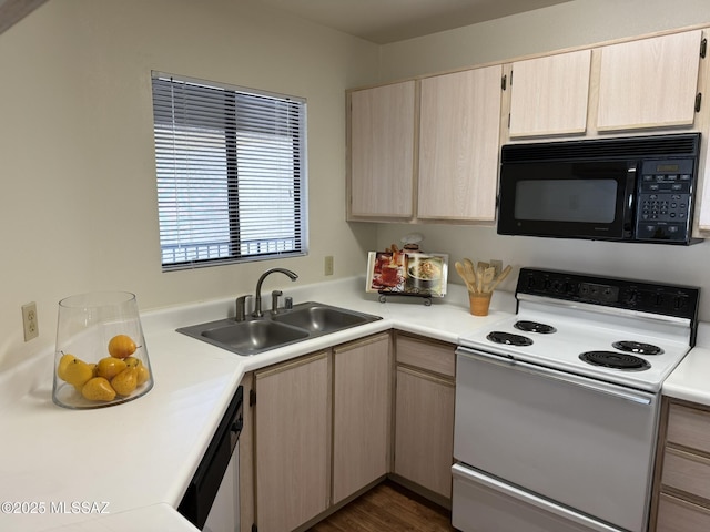 kitchen with light brown cabinets, black microwave, white range with electric cooktop, light countertops, and a sink