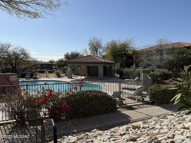 pool with a patio and fence