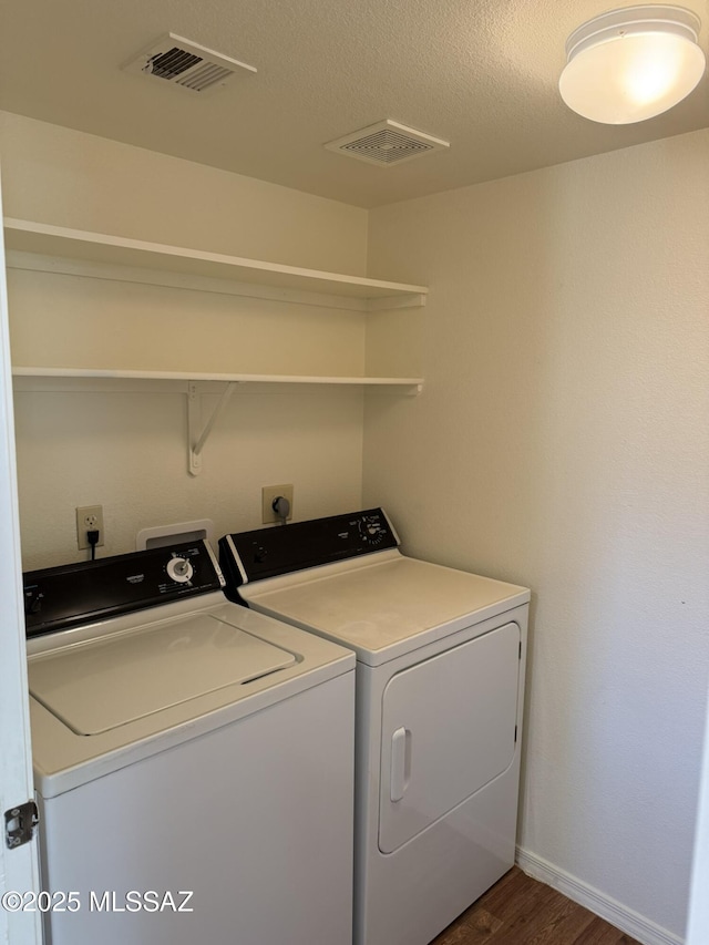 laundry area featuring laundry area, independent washer and dryer, visible vents, and dark wood-style flooring