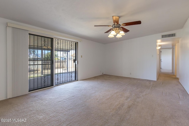 spare room featuring ceiling fan and light carpet