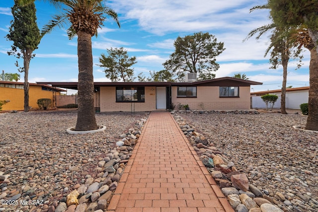 ranch-style house with cooling unit