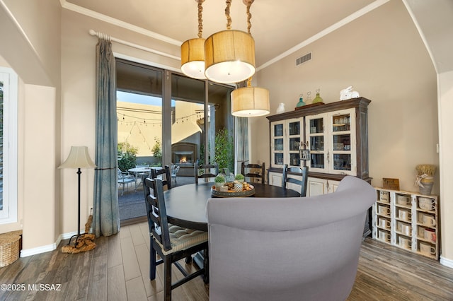 dining area featuring dark hardwood / wood-style flooring and ornamental molding