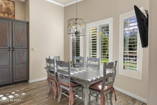 dining room featuring a healthy amount of sunlight, dark hardwood / wood-style floors, and ornamental molding