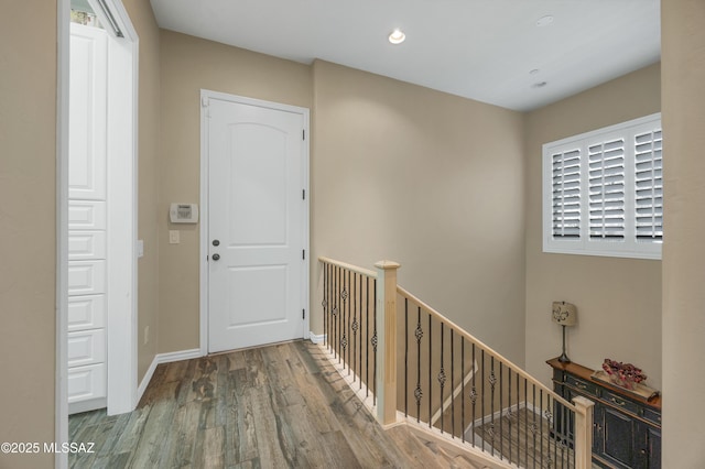 corridor with hardwood / wood-style flooring