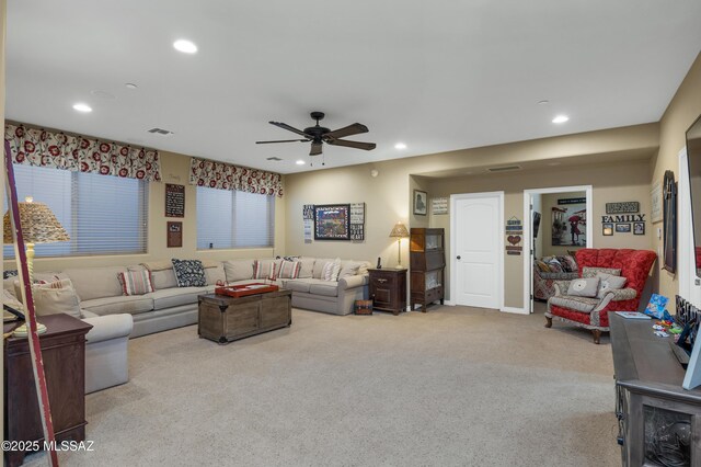 carpeted living room featuring ceiling fan