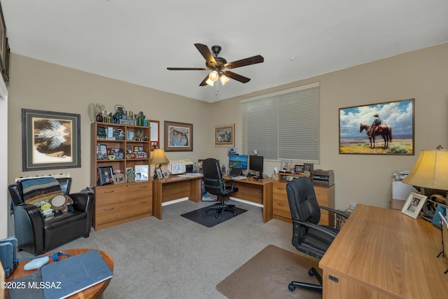 carpeted office featuring ceiling fan