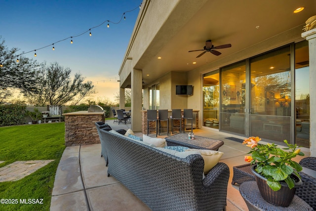 view of patio with an outdoor kitchen, ceiling fan, and an outdoor living space