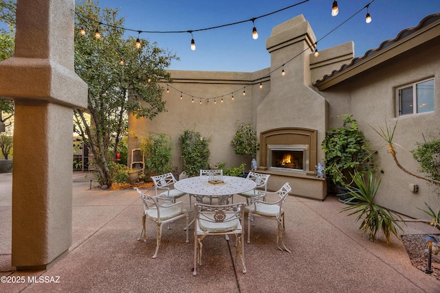 view of patio featuring exterior fireplace