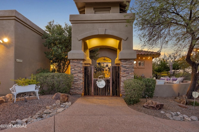 view of exterior entry at dusk