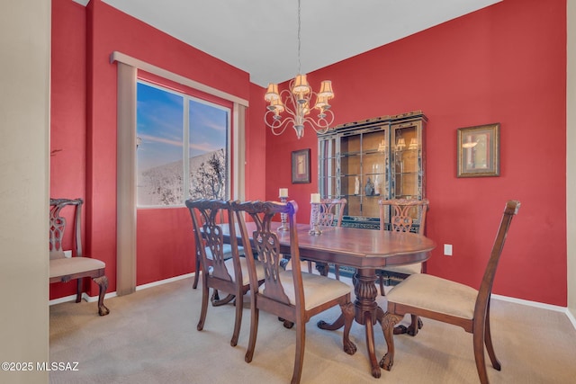 carpeted dining space featuring a mountain view and an inviting chandelier