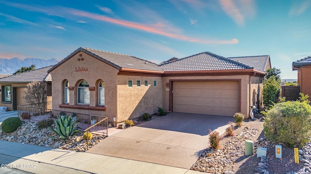 view of front of home with a garage and a mountain view