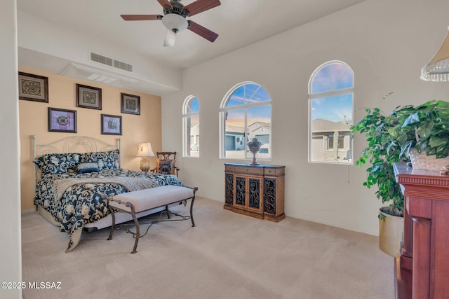 bedroom with ceiling fan and light carpet