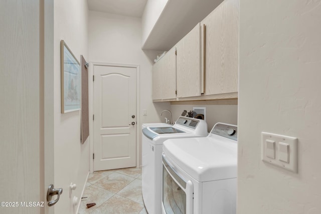 laundry area featuring cabinets, light tile patterned floors, independent washer and dryer, and sink