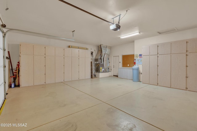 garage featuring heating unit and a garage door opener