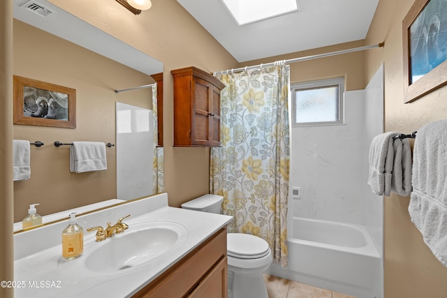 full bathroom featuring shower / tub combo with curtain, toilet, a skylight, vanity, and tile patterned flooring