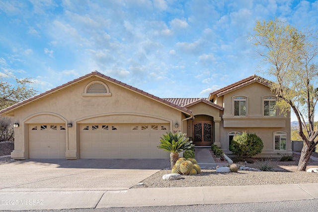 mediterranean / spanish-style home with a garage