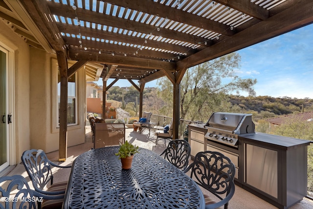 view of patio featuring exterior kitchen, area for grilling, an outdoor hangout area, and a pergola