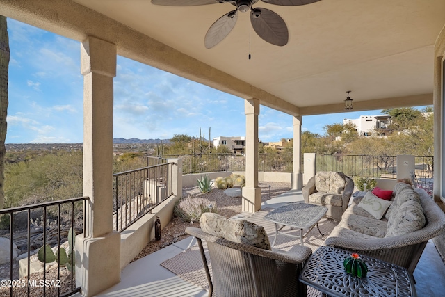 view of patio with ceiling fan and a balcony