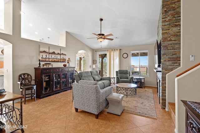 tiled living room featuring vaulted ceiling and ceiling fan