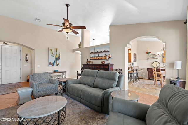 tiled living room with vaulted ceiling and ceiling fan