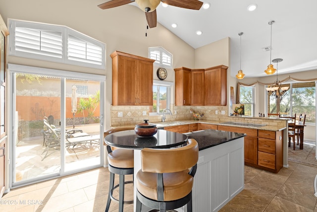 kitchen featuring pendant lighting, plenty of natural light, and tasteful backsplash