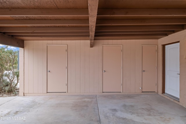 interior space featuring wood ceiling and wooden walls